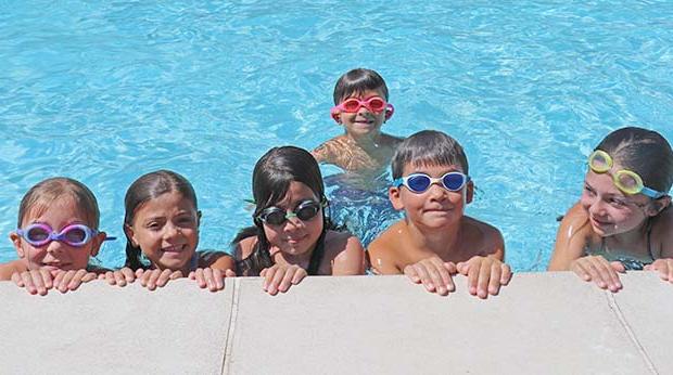 Kids smiling in the pool at Poly Summer camp